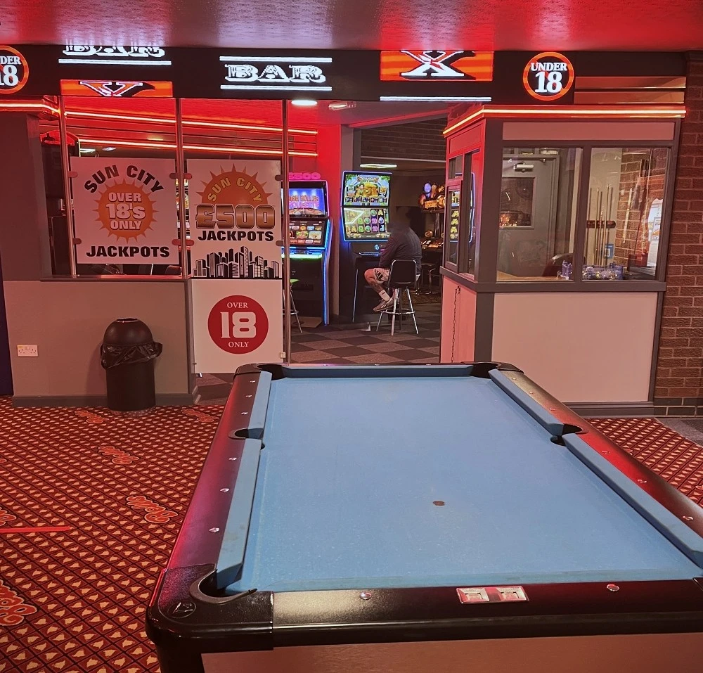 blue pool table in arcade