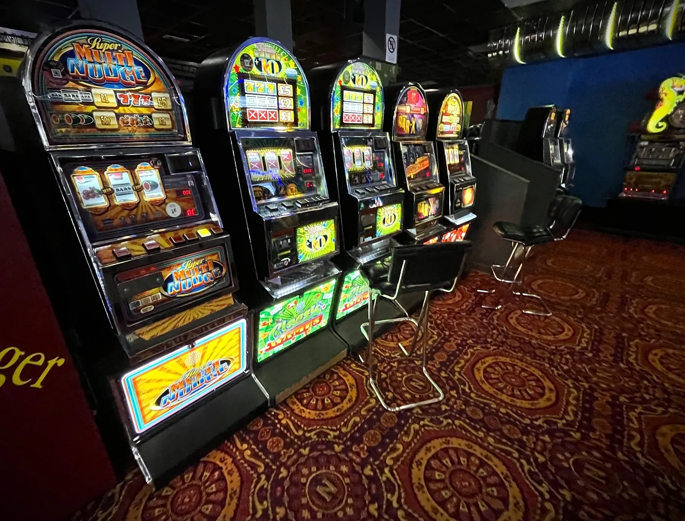 row of classic arch-top oxo fruit machines