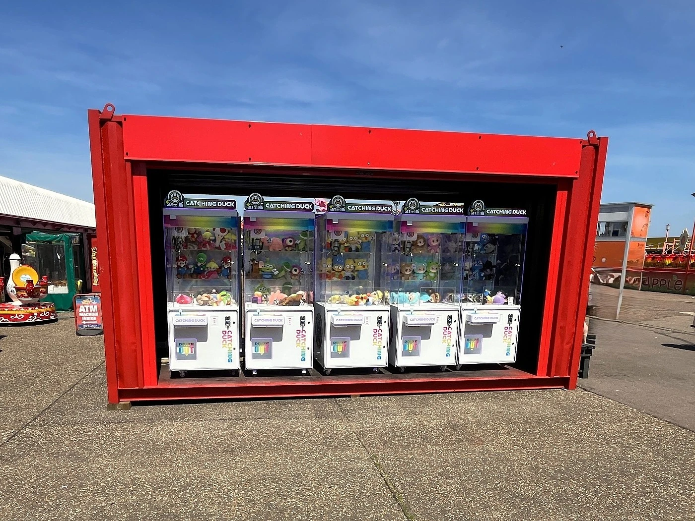 row of catching duck claw machines inside a container