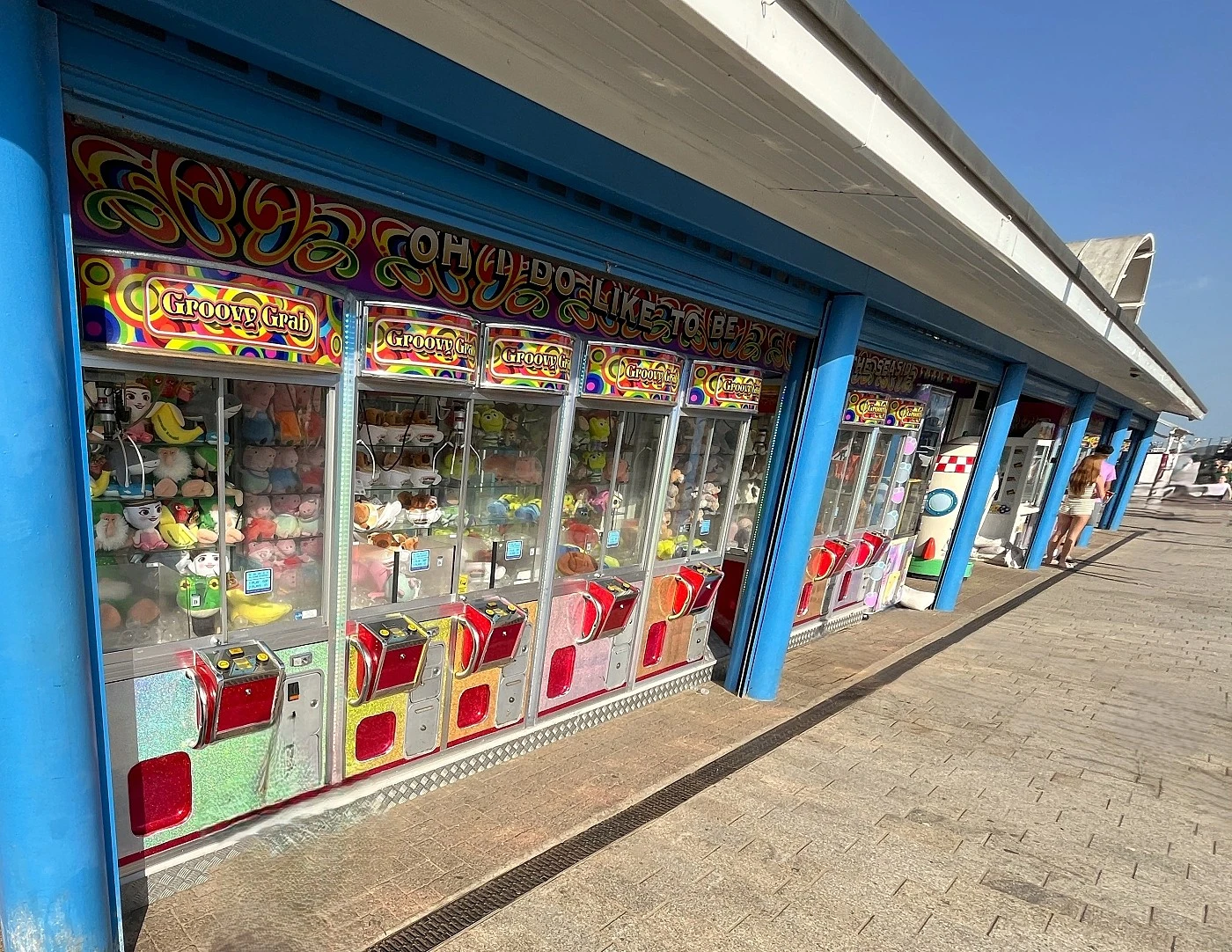 a row of groovy grab claw machines outside the mint arcade