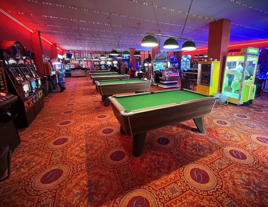 a row of arcade pool tables