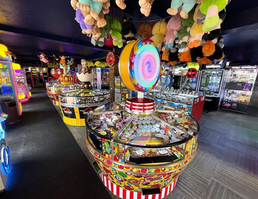sweet falls coin pusher with plush prizes above